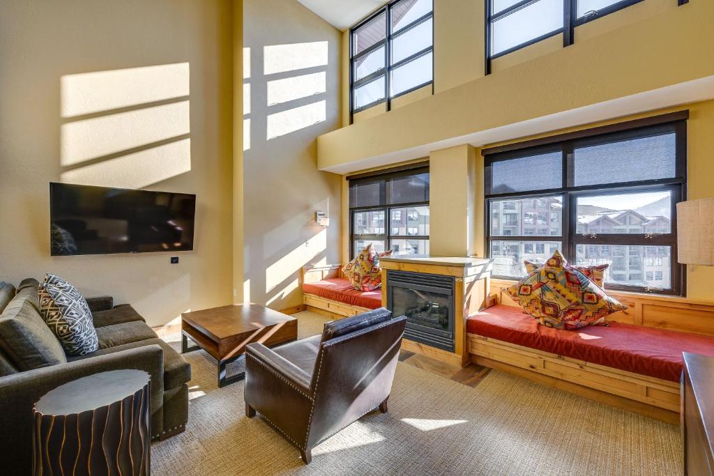 a large living room with a fireplace and windows at Ski-InandSki-Out Park City Condo Fireplace and View! in Park City