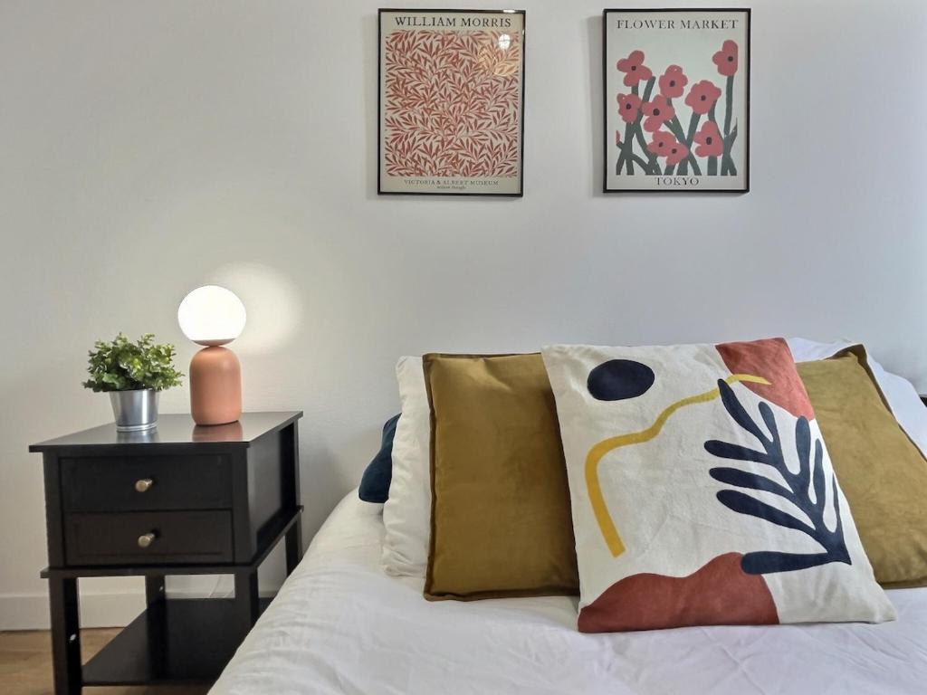 une chambre avec un lit et une table de chevet avec une lampe dans l'établissement Cornas - Centre Historique Calme, à Tournon-sur-Rhône