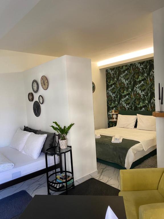 a hotel room with a bed and a couch at ΑΘΗΝΑ HOME in Ioannina