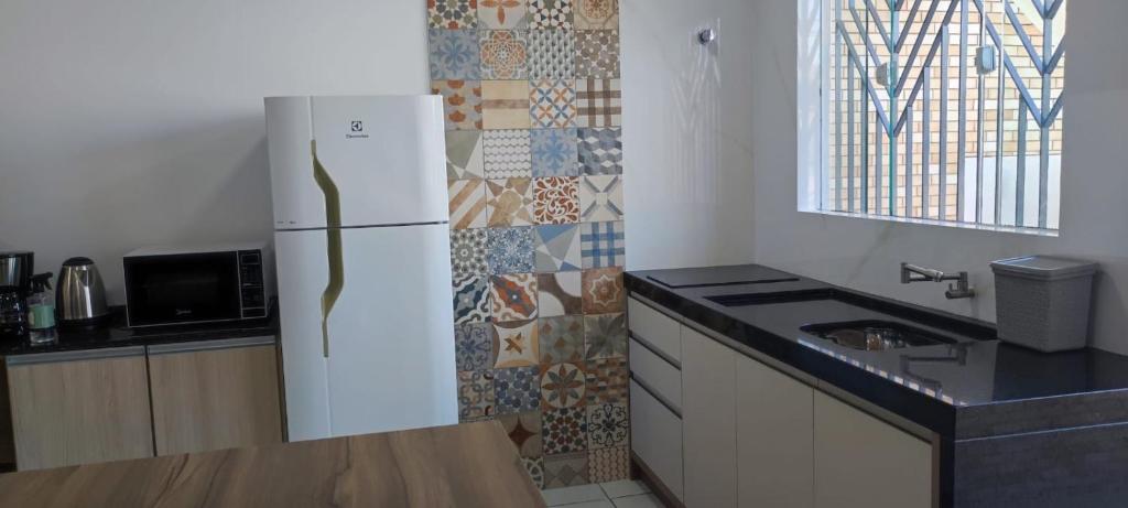 Kuchyň nebo kuchyňský kout v ubytování Apto 1 Quarto com estilo e Conforto