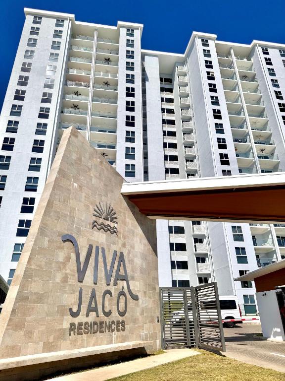a large building with a sign in front of it at Jacó Pacífico in Jacó