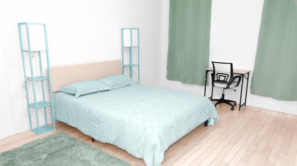a bedroom with a bed and a desk and a table at Relaxx - 3Brighton Beach - Green3057 in Brooklyn