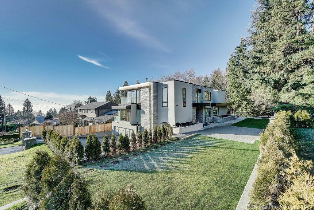 a house with a large yard with trees at Quiet Suites Up to 8 Guests Near DTVan Monthly Option in West Vancouver