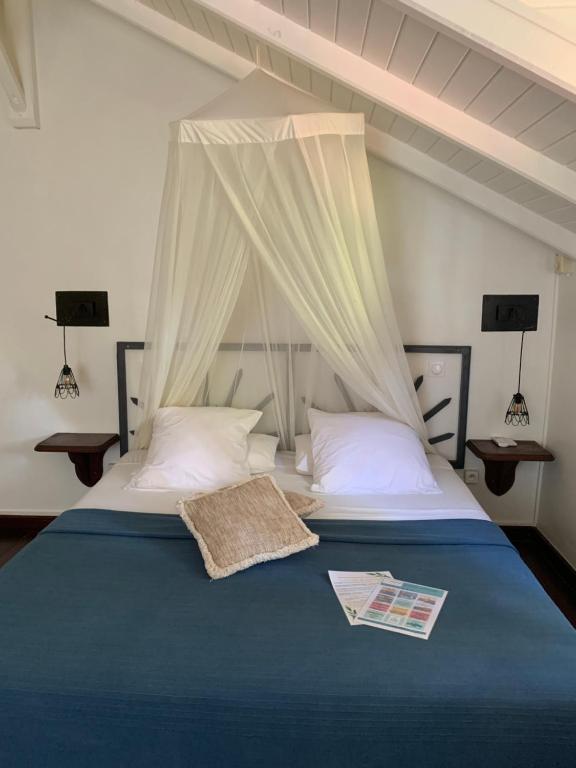 Postel nebo postele na pokoji v ubytování Caraib'Bay Hotel