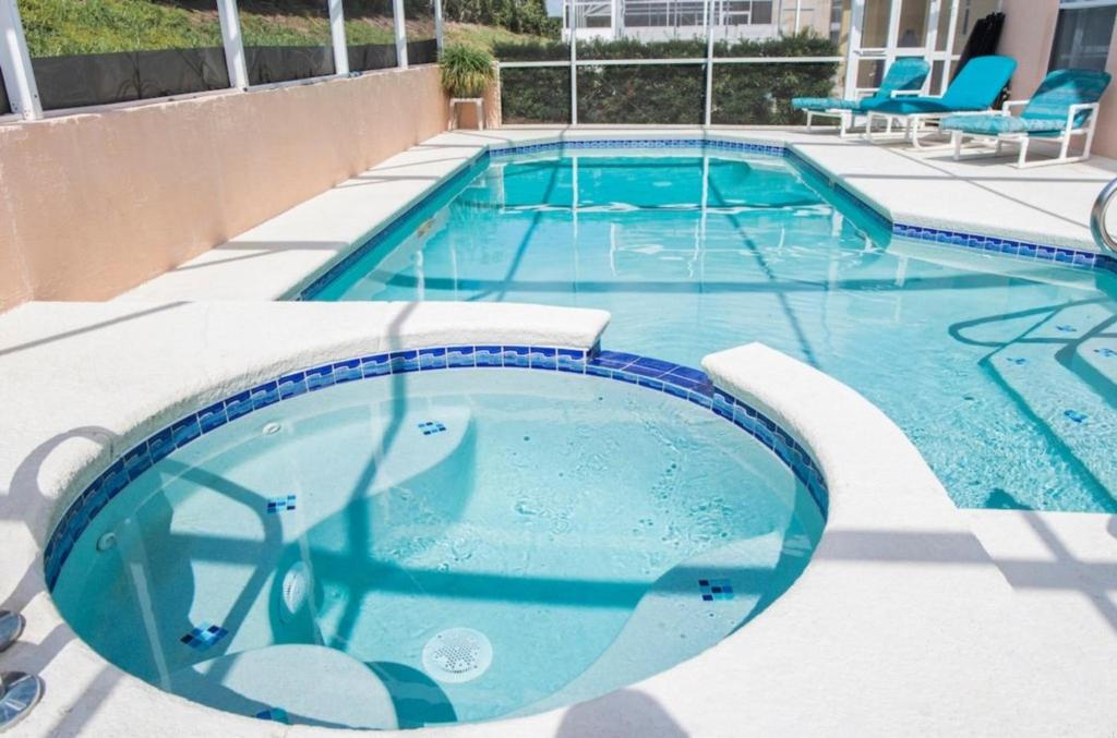 a large pool with blue water in a building at Super Mario Hideaway - Pool, Spa, Game Room Fun! in Davenport