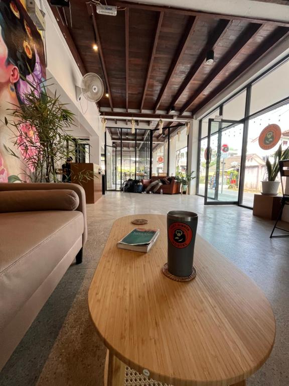 a coffee table in a living room with a cup on it at Lazy Gibbon 2 Chiang Mai - Haiya in Chiang Mai