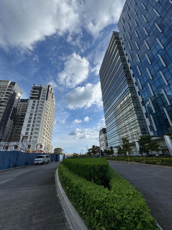 a street in a city with tall buildings at Casa de gloria in Davao City