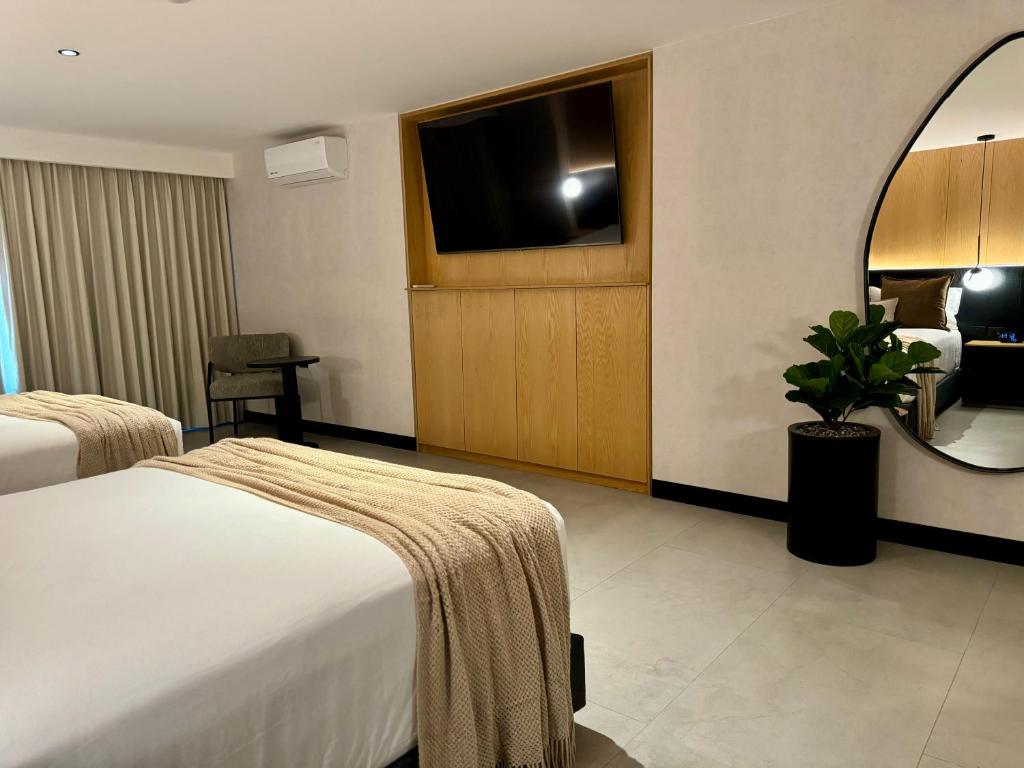 Postel nebo postele na pokoji v ubytování Hotel Aló Degollado