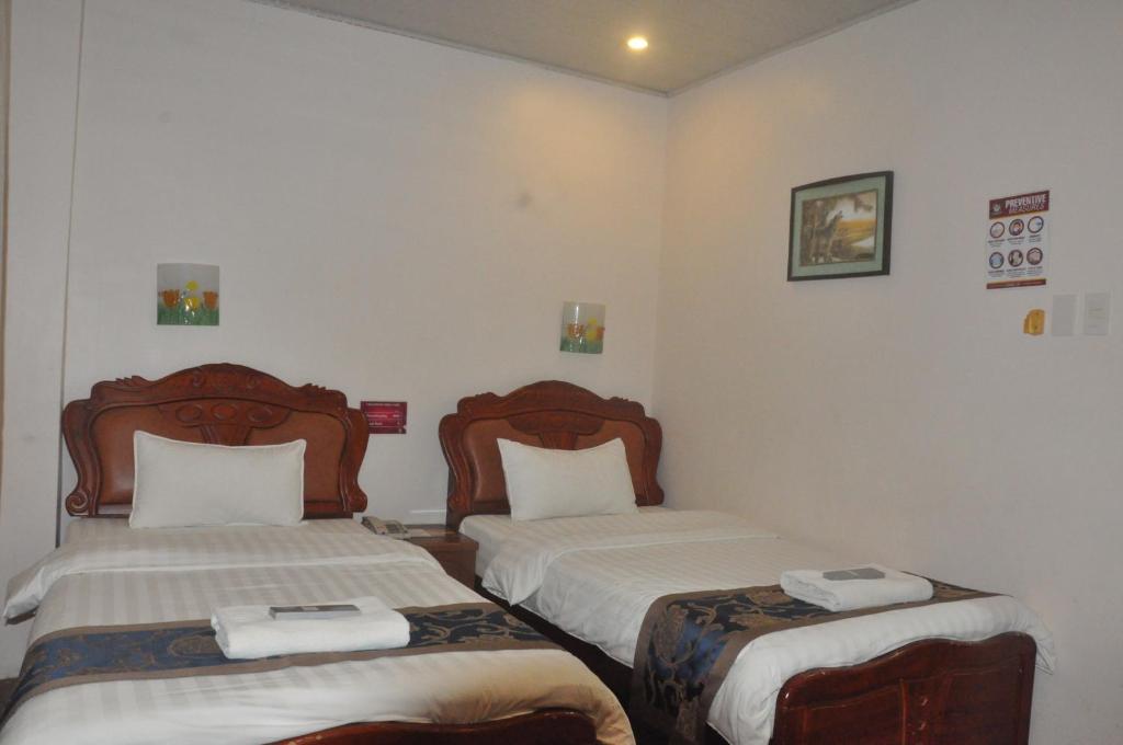 Postel nebo postele na pokoji v ubytování A&A Plaza Hotel