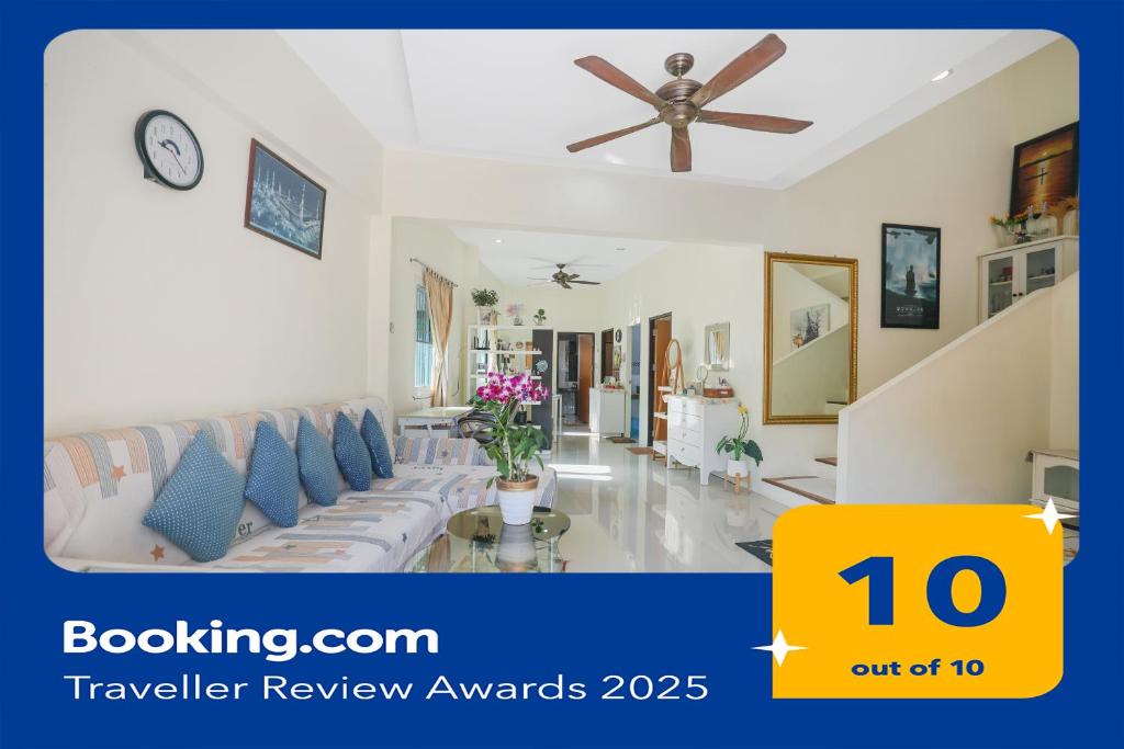 a living room with a couch and a clock at Phuket 3-Bedrooms Private XLarge Family Villa in Chalong 