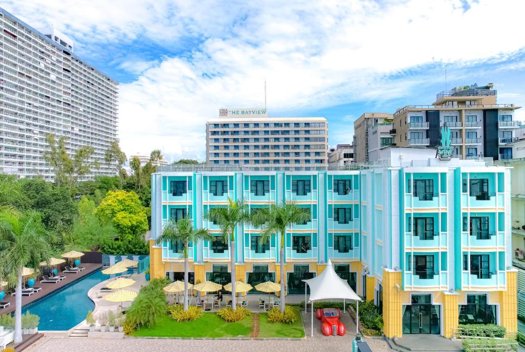 a blue building with a pool in a city at Wave Hotel Pattaya in Pattaya