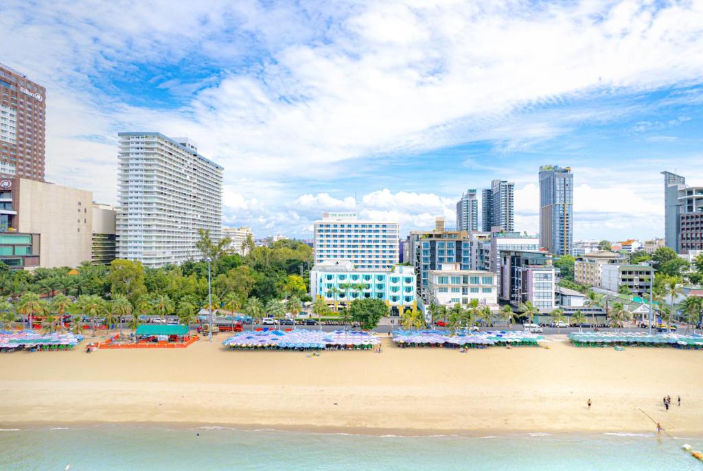 a beach in a city with tall buildings at Wave Hotel Pattaya in Pattaya