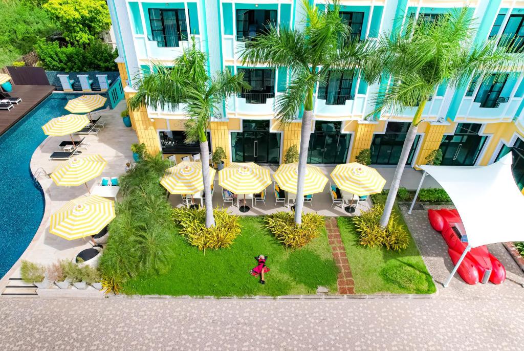 an aerial view of a hotel with tables and umbrellas at Wave Hotel Pattaya in Pattaya