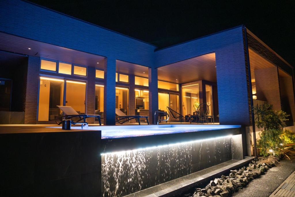 a house with a swimming pool at night at EZRA VILLA shirahama in Shirahama