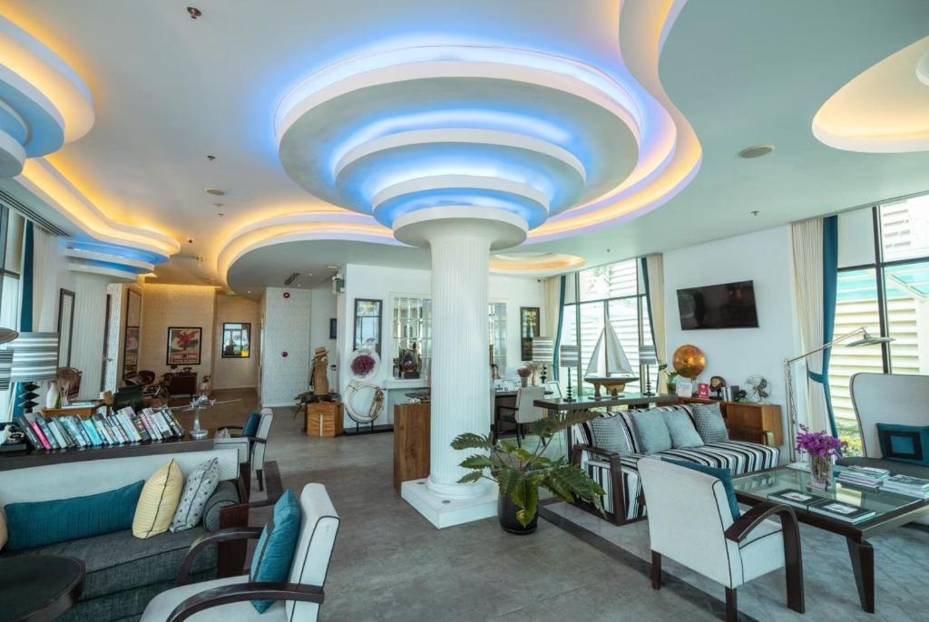 a living room with a blue and white ceiling at Wave Hotel Pattaya in Pattaya