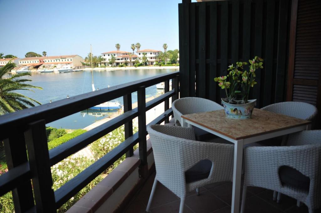 a table on a balcony with a view of a river at Residence La Bricola 239 in I Casoni