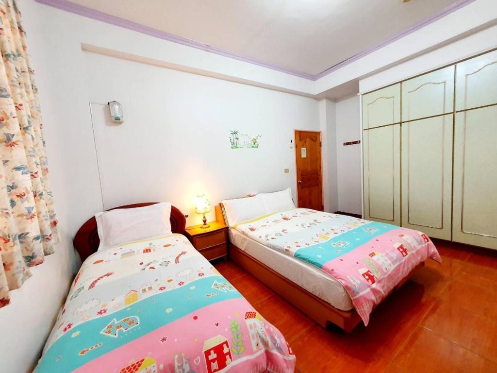 Postel nebo postele na pokoji v ubytování Yilan Xiang Feng Homestay