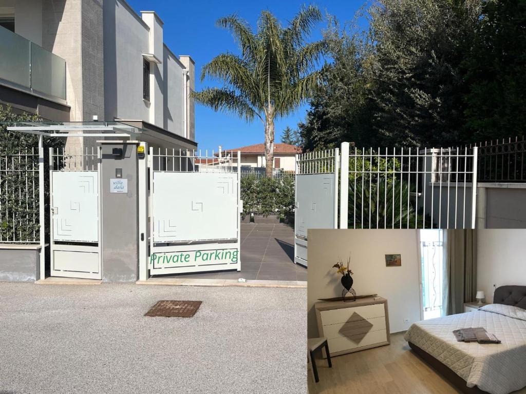 a house with a white fence and a room with a bed at VILLA DALU not only Holidays in Trani