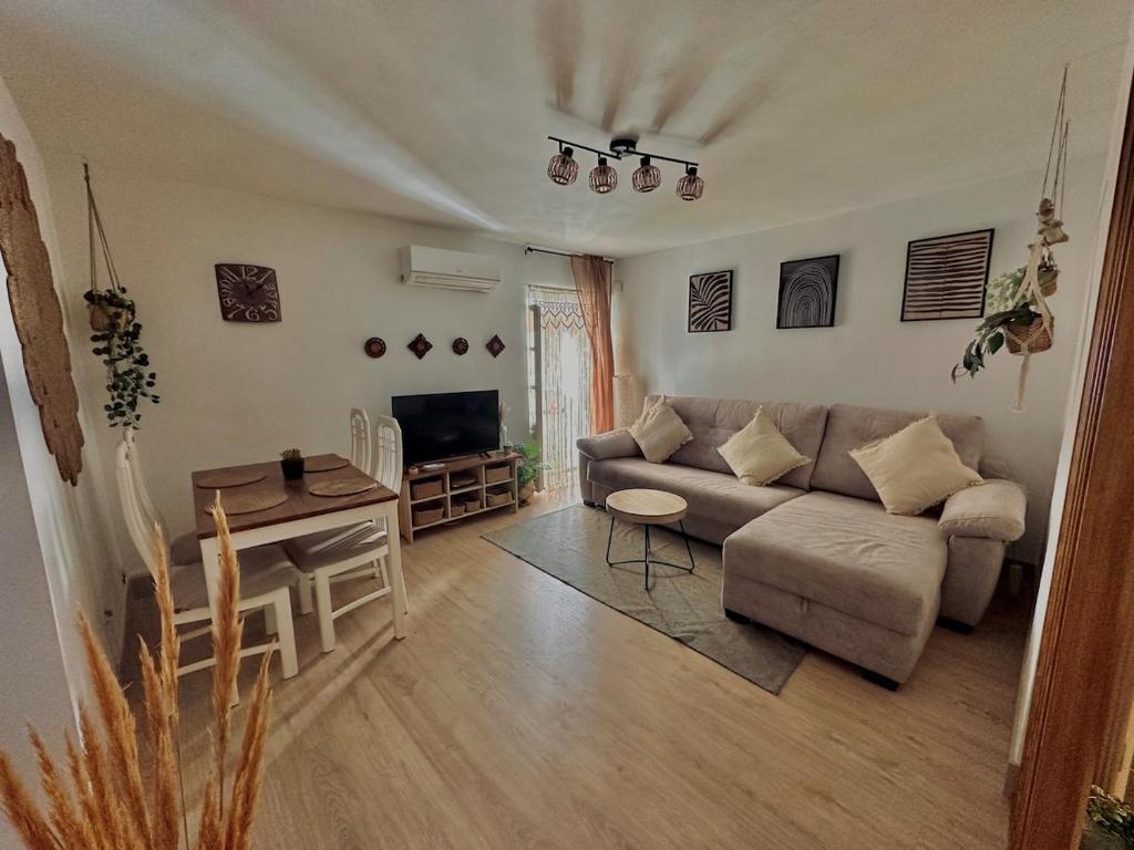 a living room with a couch and a table at Accommodation near the Cathedral LaCuevitadeLeo in Toledo