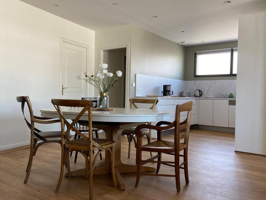 une cuisine et une salle à manger avec une table et des chaises dans l'établissement Magnifique appartement à 100 m de la plage, à Agon-Coutainville