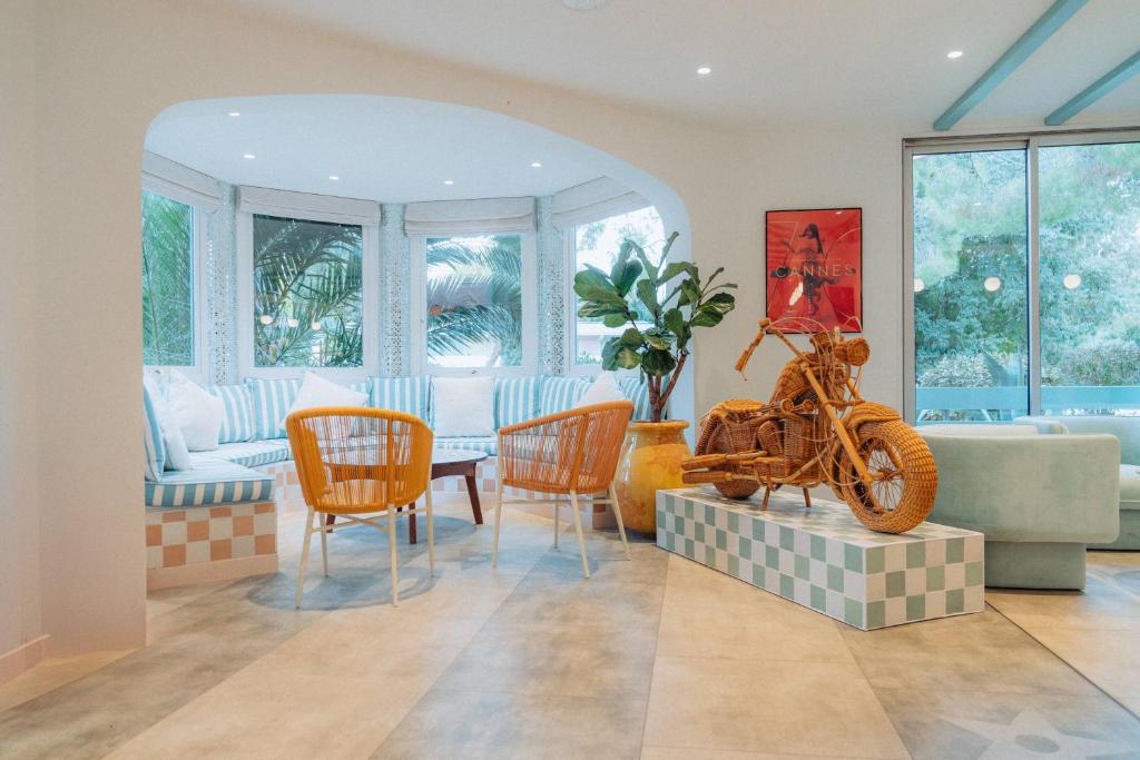 a living room with a bike on a table and chairs at Kyriad Cannes - Mandelieu in Cannes