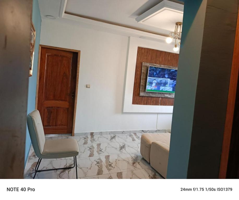 a room with a chair and a bed and a window at residence Eden Garden 1 in Abidjan