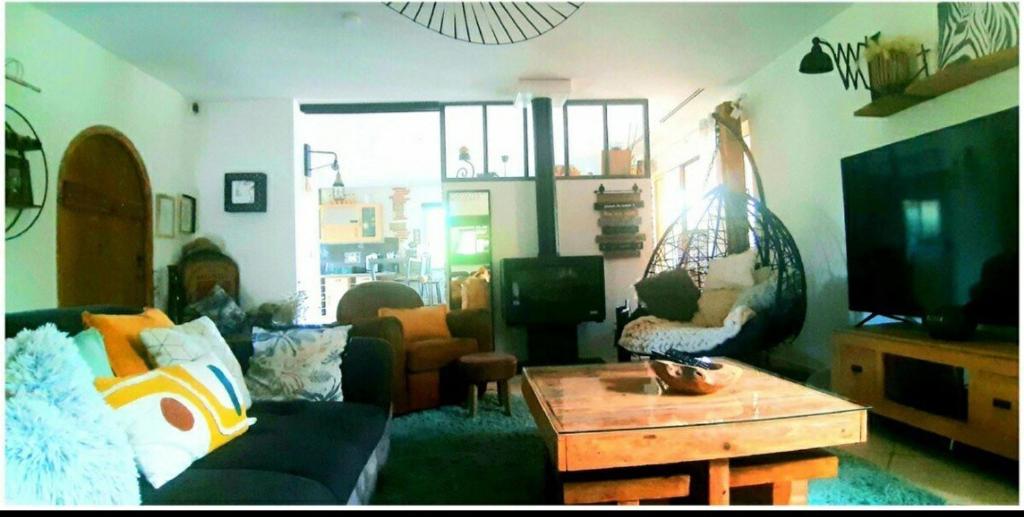 a living room with a couch and a table at Gers habitation in Montégut
