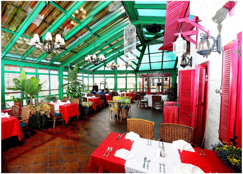 a restaurant with tables and chairs with red and white tables at Narantuul Hotel in Ulaanbaatar