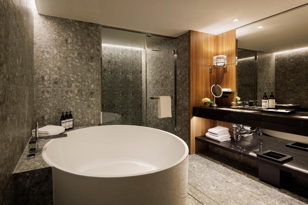 a bathroom with a tub and a sink at Hyatt Regency Tokyo in Tokyo