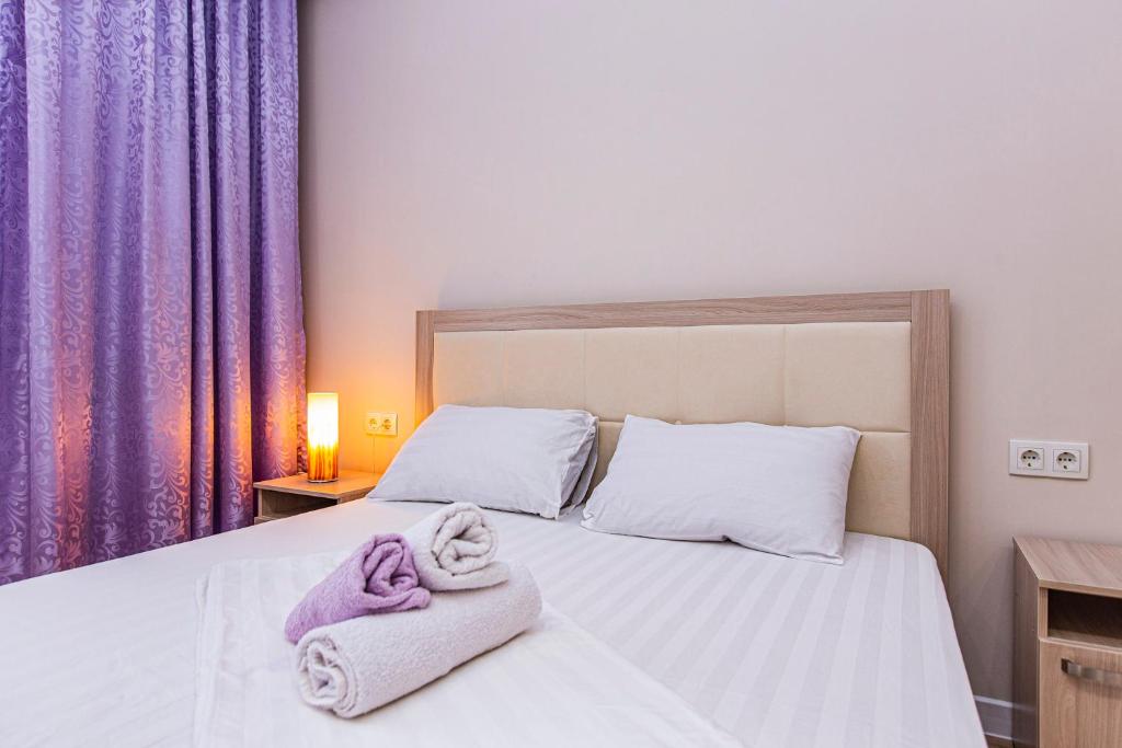 a bedroom with a bed with towels on it at Просторная 3х комнатная квартира в центре Алматы in Almaty