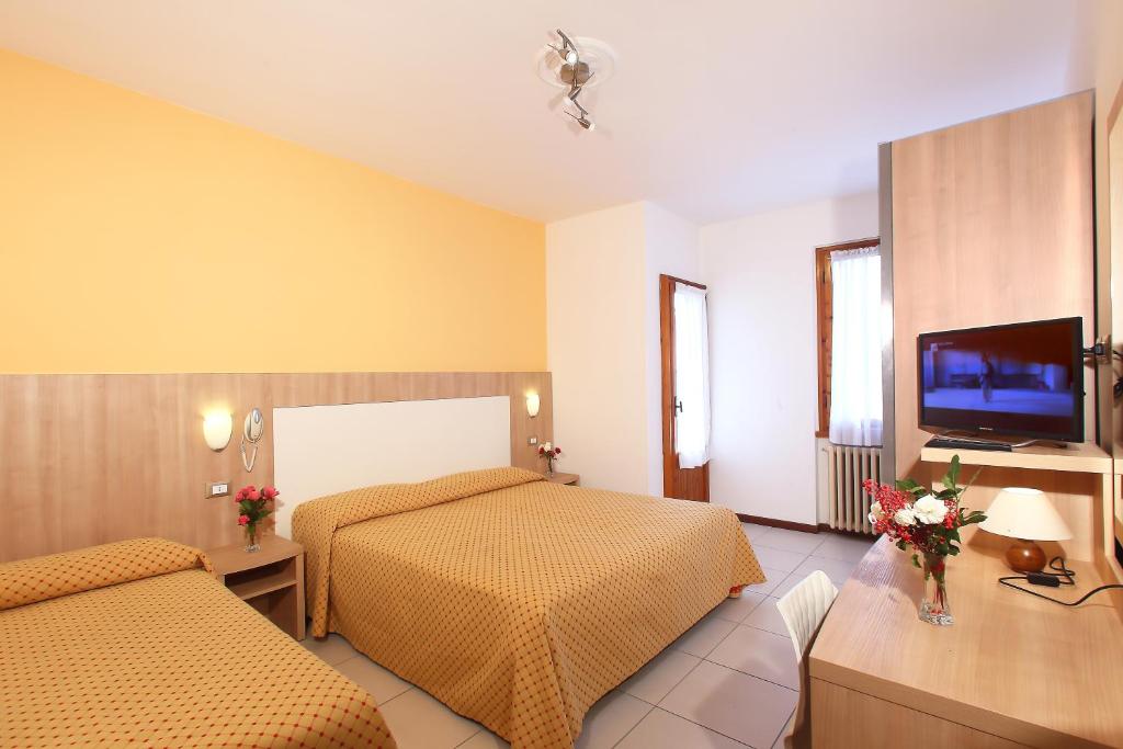 Postel nebo postele na pokoji v ubytování Hotel Marrani