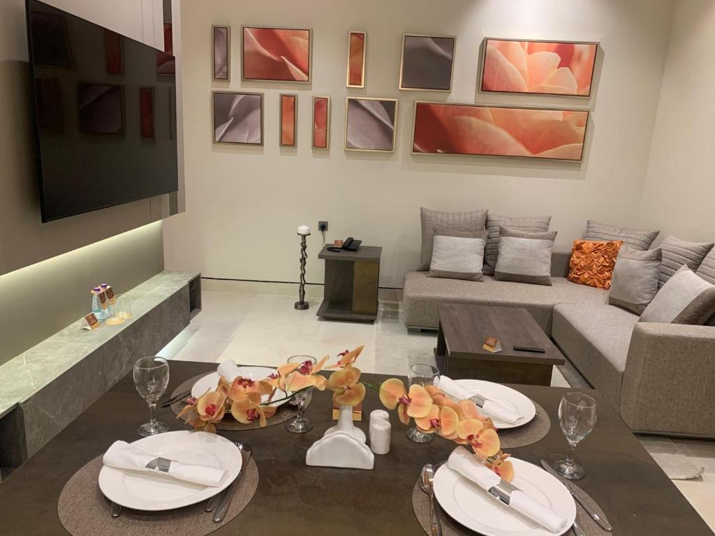 a living room with a table and a couch at فندق ليورا Liora Hotel in Riyadh