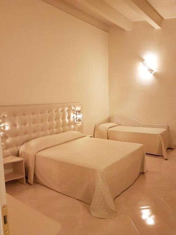 Postel nebo postele na pokoji v ubytování Hotel Azzurra