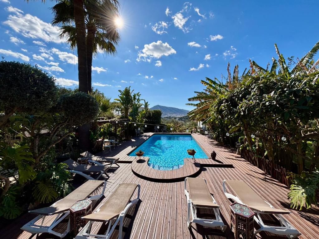 a pool with chaise lounge chairs and a wooden deck at Hotel Altea Paradise 1917 - Adults Only in Altea