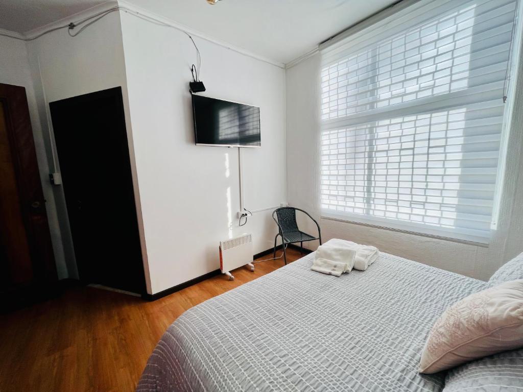 Postel nebo postele na pokoji v ubytování Hotel Nomada Osorno