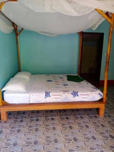 a bed with a canopy in a room at Phukhao thong in Ban Bang Chak