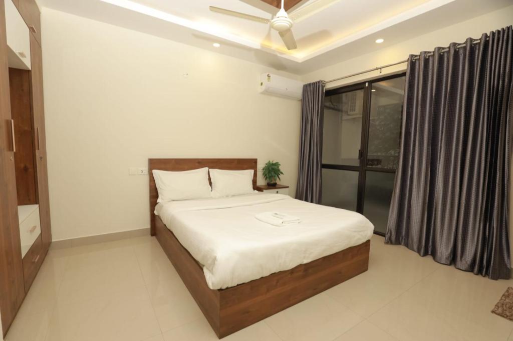 a bedroom with a bed and a window at VVP Rooms in Cochin