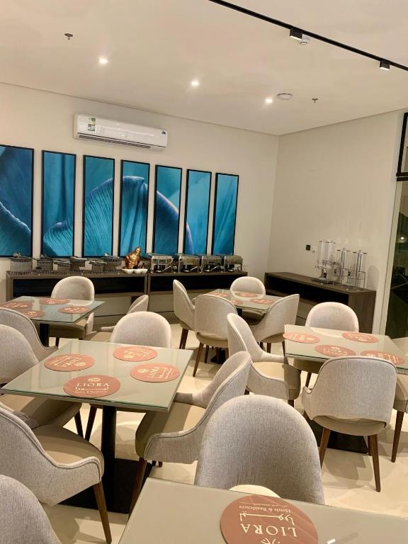 a waiting room with tables and chairs and windows at فندق ليورا Liora Hotel in Riyadh
