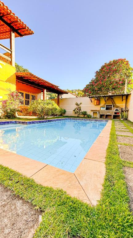 a swimming pool in front of a house at Sua Casa na Serra in Itaipava