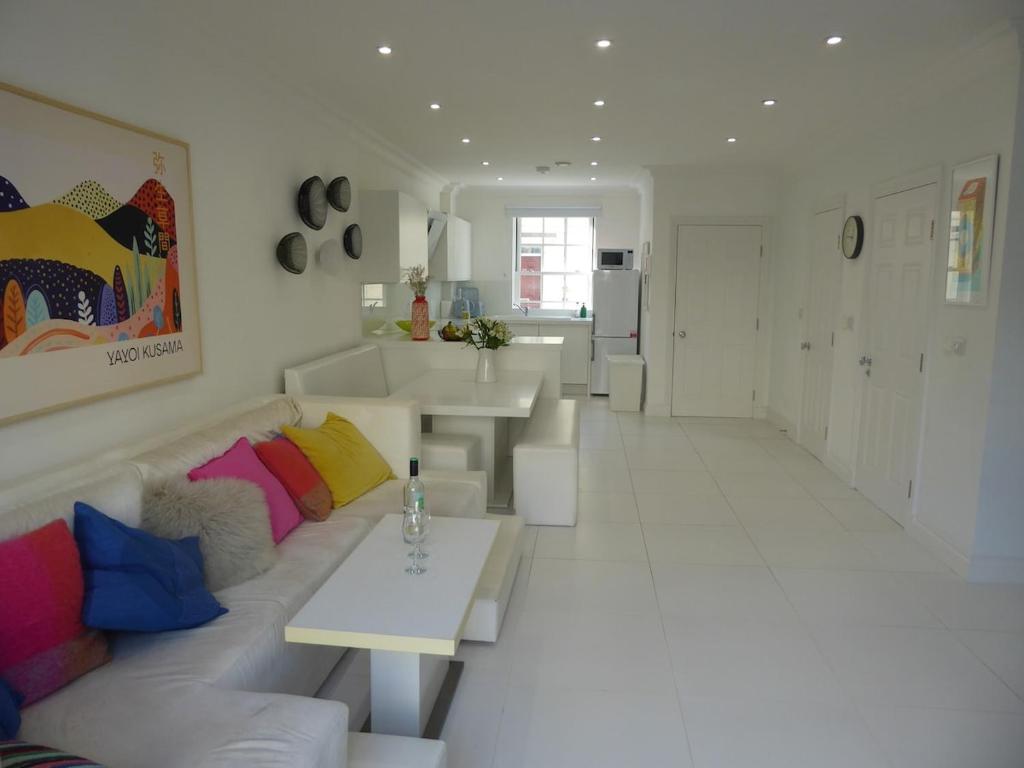 a white living room with a couch and a table at Modern townhouse in Mountwise in Plymouth