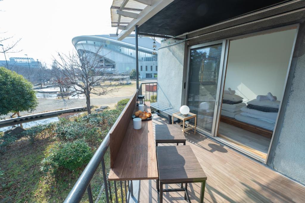 a balcony with a wooden bench on a building at リトリート神戸 広々70m2 一軒家貸切 ノエビアスタジアム隣接 in Kobe