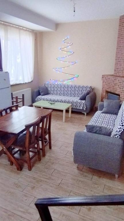 a living room with couches and a table and a tree at bakuriani in Bakuriani