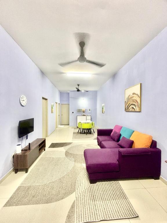 a living room with a purple couch and a table at H&Z Guesthouse Kulim Hi-Tech - Free Wifi - Netflix in Kulim