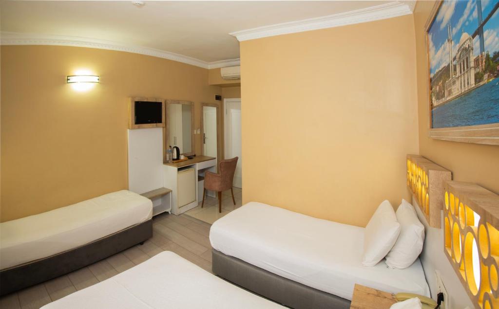 Postel nebo postele na pokoji v ubytování GRAND VATAN HOTEL