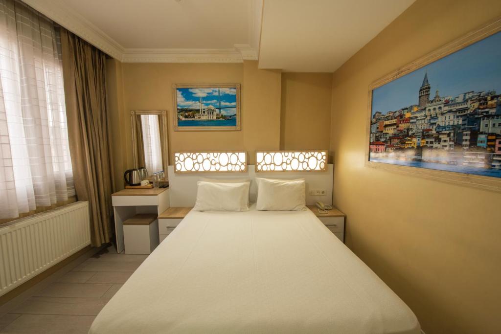 Postel nebo postele na pokoji v ubytování GRAND VATAN HOTEL