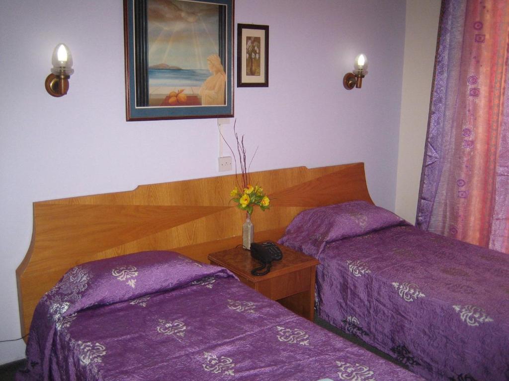 Postel nebo postele na pokoji v ubytování Onisillos Hotel
