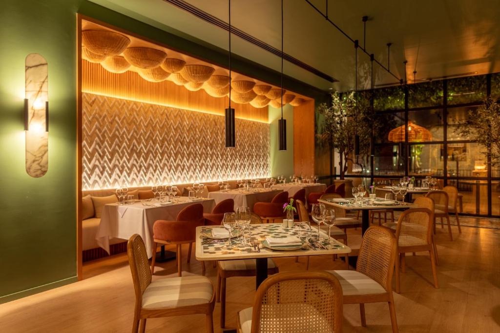 a restaurant with tables and chairs in a room at Desert Rose Resort in Hurghada