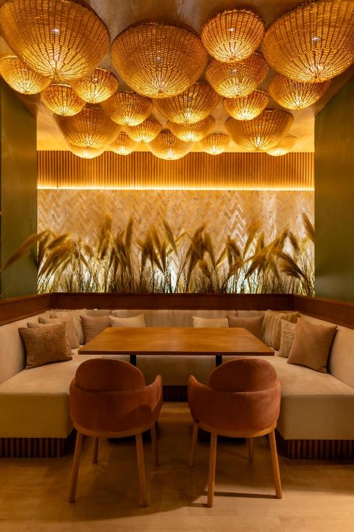 a restaurant with a couch and a table and two chairs at Desert Rose Resort in Hurghada
