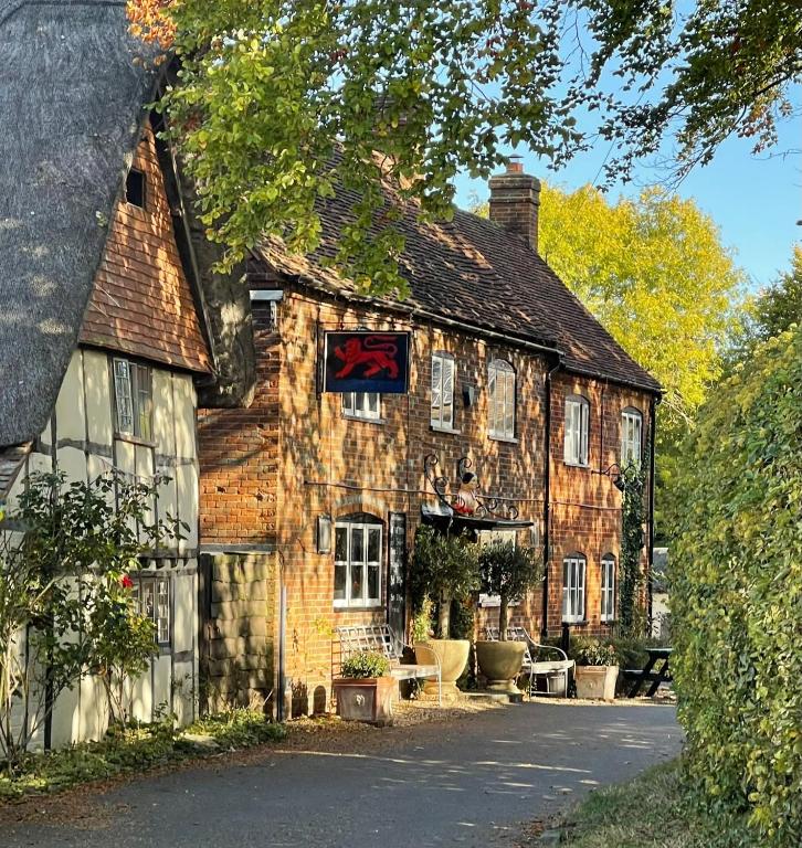 an old building with a sign on the front of it at The Red Lion in Blewbury