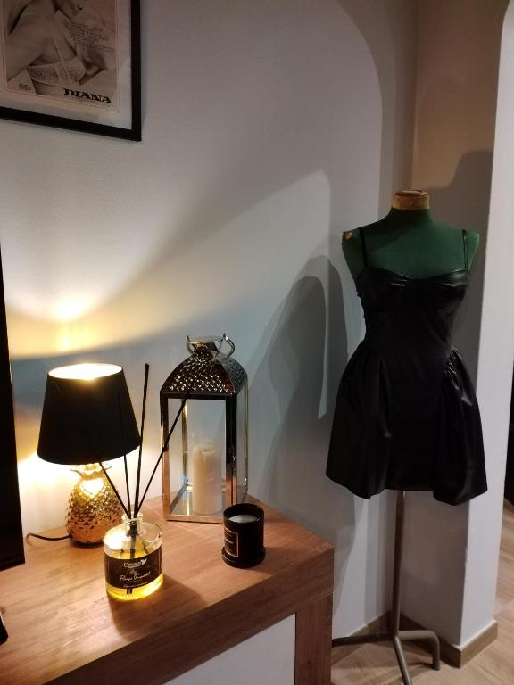 a dress on a mannequin and a lamp on a table at La Corte di Peretola Boutique Apartment in Florence